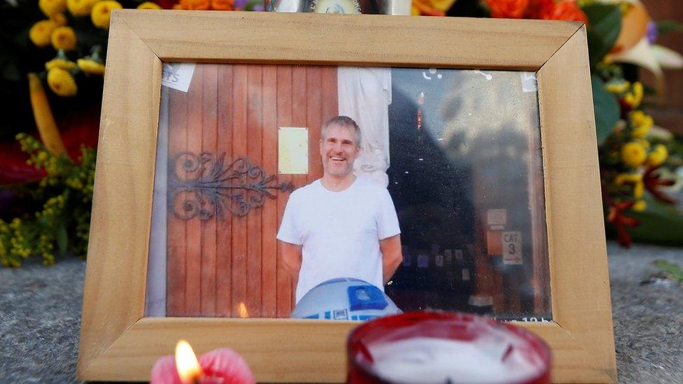 Picture of Vincent Loquès, sexton of the Notre Dame church, is seen with candles and flowers in front of the church in Nice, October 30, 2020