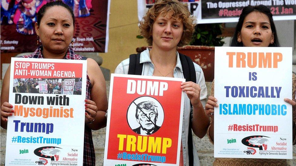 Members of New Socialist Alternative Indian section of the committee for the workers international fighting for Democratic Socialism holds placards and shouts slogans against the newly sworn United States of American President Donald Trump in Bangalore