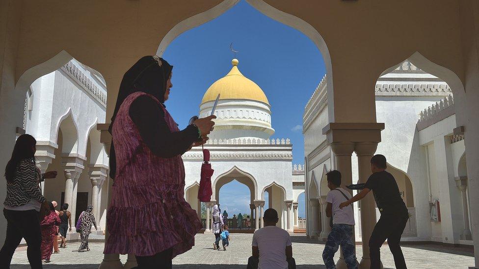 People walk through the hallways of the Golden Mosque in Cotabato City in Maguindanao Province, Philippines