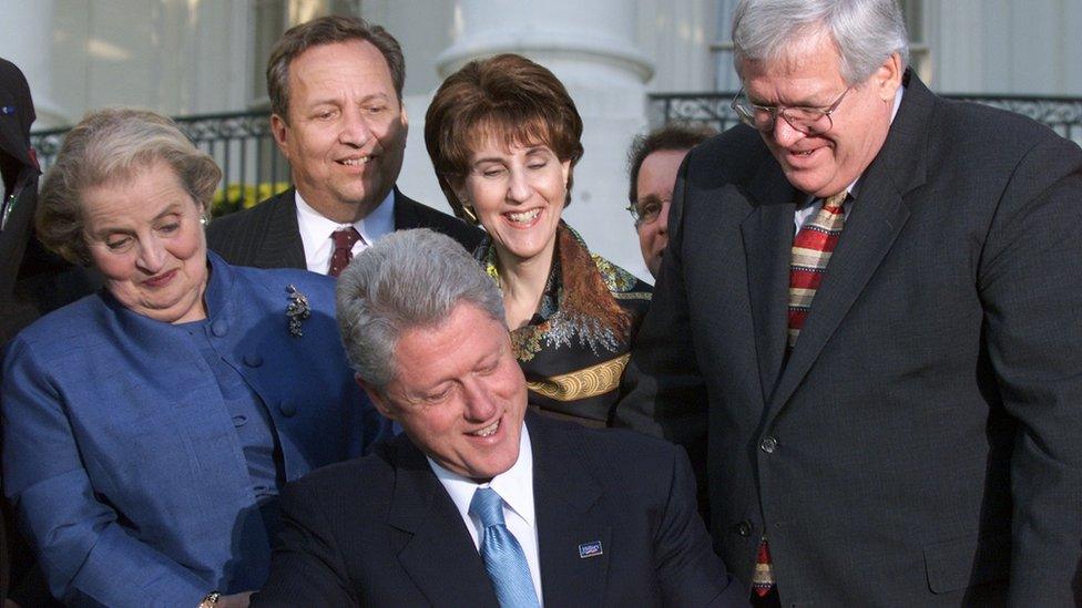 U.S. President Bill Clinton is surrounded by Secretary of State Madeleine Albright, Treasury Secretary Lawrence Summers, Trade Representative Charlene Barshefsky, and House Speaker Dennis Hastert while signing a Permanent Normal Trade Relations for China Bill, at the White House, October 10, 2000