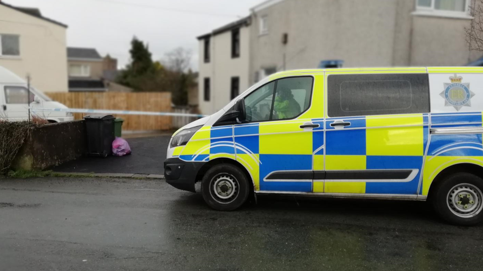 Police van and tape outside the Dearham house