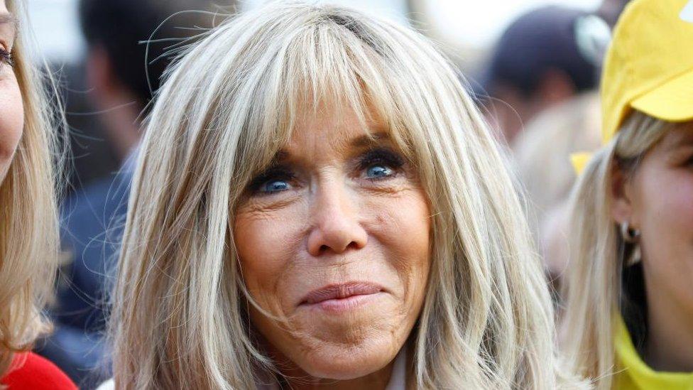 Brigitte Macron smiles at an event