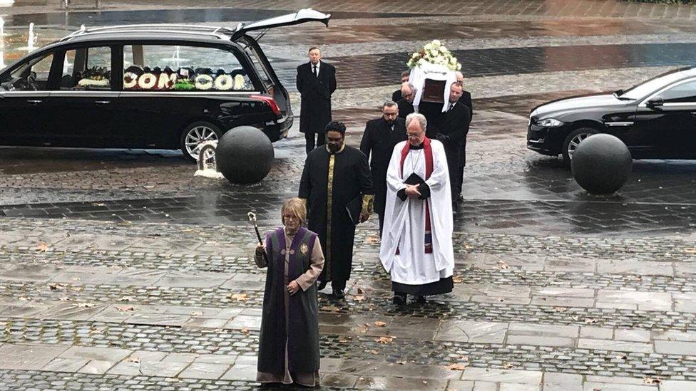 Coffin being carried