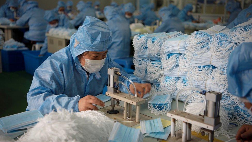 Employees work on a production line for surgical masks at a factory, following an outbreak of the novel coronavirus in the country, in Nantong, Jiangsu province, China