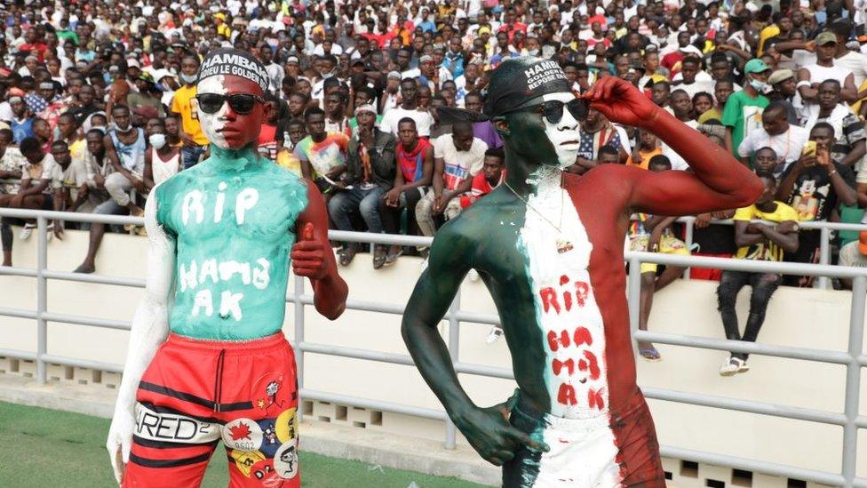 People gather for a ceremony organized by Rally of Houphouetists for Democracy and Peace (RHDP) political party in homage to the late Ivory Coast Prime Minister Hamed Bakayoko at the Olympic Stadium in Abidjan, Ivory Coast on March 17, 2021. Hamed Bakayoko, 56, died late Wednesday in Germany after being hospitalized for cancer