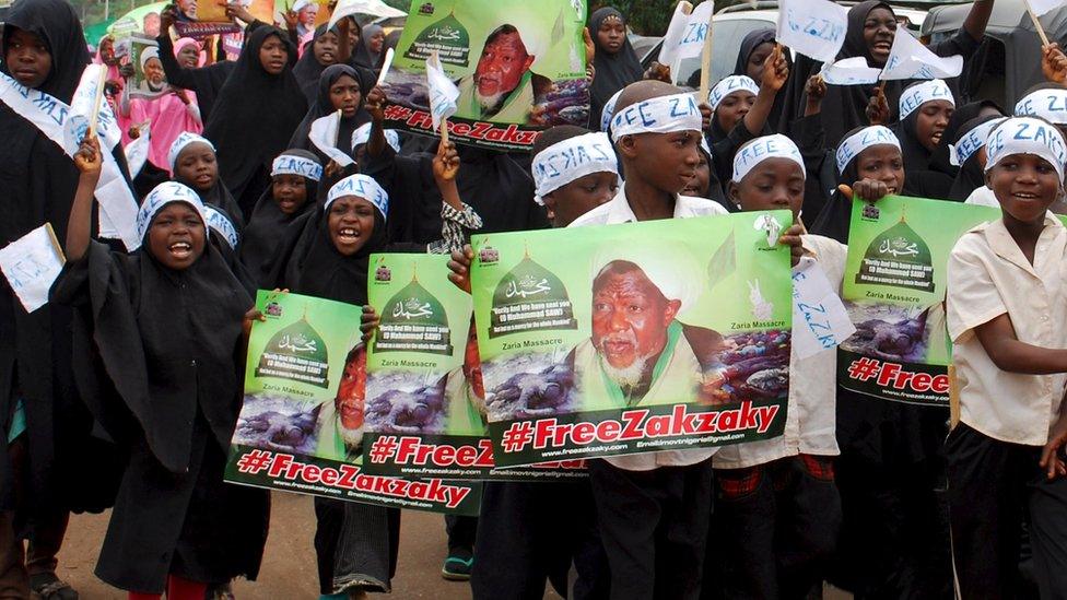 Children of members of the Islamic movement in Nigeria carry banners and shout slogans during a protest against the detention of the leader of Shi"ites in Nigeria