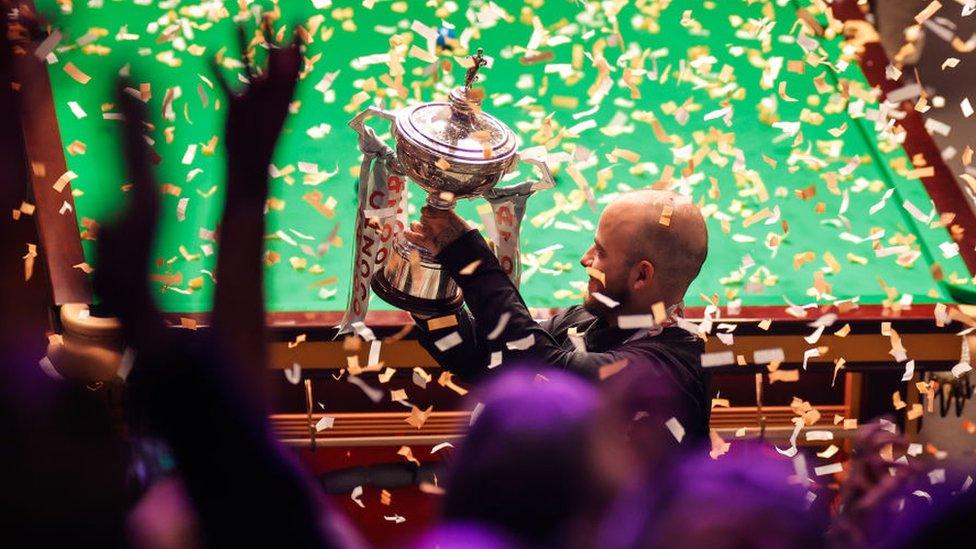 Luca Brecel of Belgium holds the trophy at the 2023 Cazoo World Championship at Crucible Theatre on 1 May 2023 in Sheffield, England