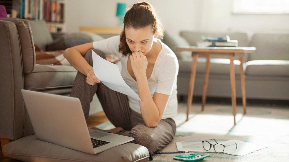 Woman looking at laptop