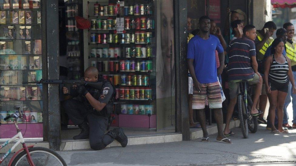 A policeman takes up position during an operation against drug dealers in Cidade de Deus slum in Rio de Janeiro, Brazil, July 10, 2017