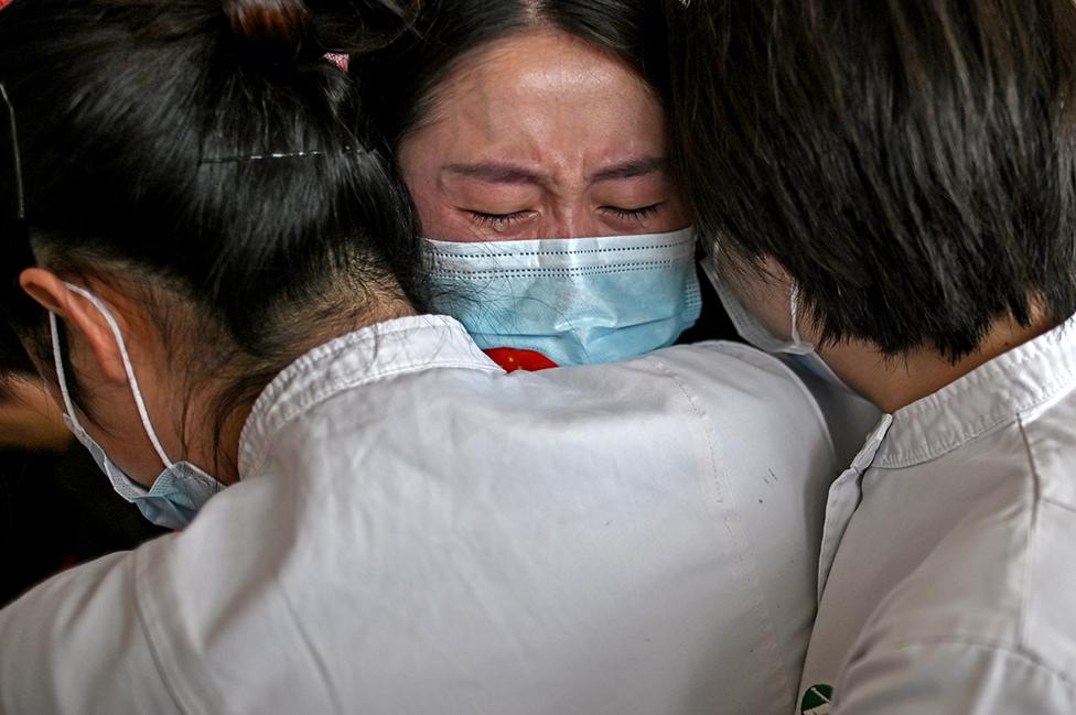 Medical staff hug nurses