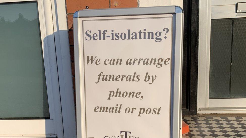 A sign telling people funerals cane be arranged from home if they are self-isolating