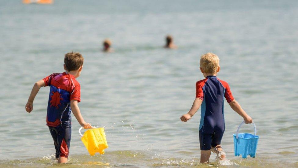 Boys playing in the sea.