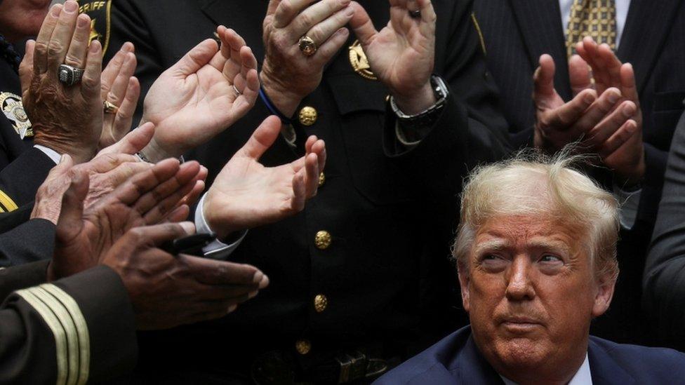 U.S. President Donald Trump listens to applause after signing an executive order on police reform during a ceremony in the Rose Garden at the White House in Washington, U.S., June 16, 2020