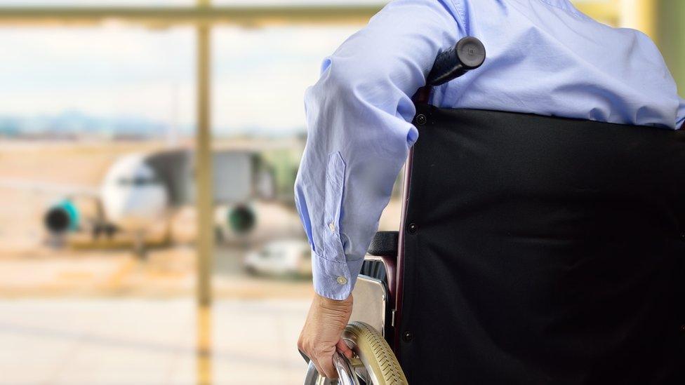 Man in wheelchair at airport