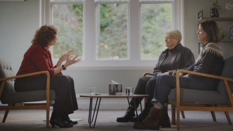 Janet (right), Liz (middle) and Professor Turi (left) sitting on chairs talking with a table between them