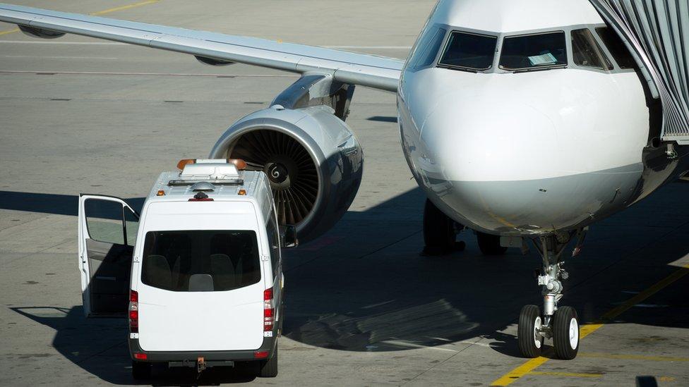 Ambulance beside aircraft