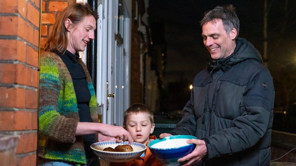 Neighbours distribute the cooked jacket potatoes