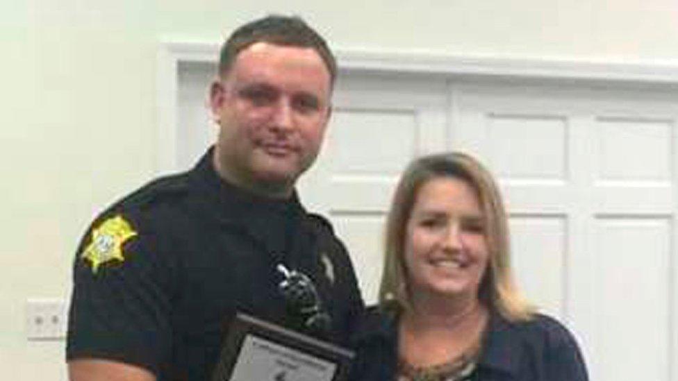 Richland County Sheriff's Department Officer Senior Deputy Ben Fields is pictured with Karen Beaman (R), Principal of Lonnie B Nelson Elementary School, after receiving an excellence award at the school in Columbia, South Carolina, on 2 November 2014