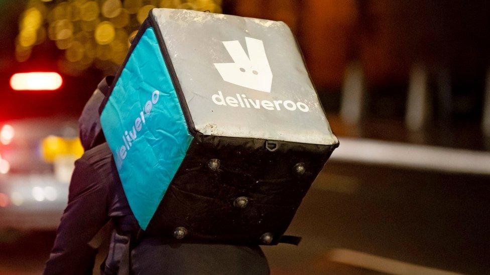 A Deliveroo rider at work at night on December 22, 2018 in Cardiff,