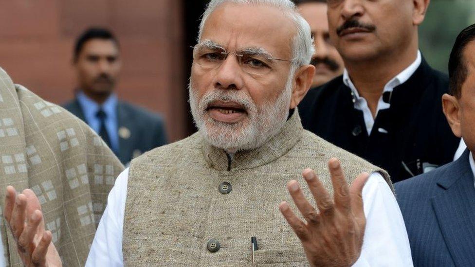 Indian Prime Minister Narendra Modi addresses media representatives after arriving for the winter session of Parliament in New Delhi on November 26, 2015