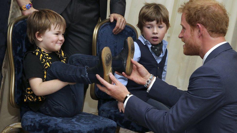 Prince Harry greeted Noah and Oscar, children of WellChild special recognition award winner, Jill Evans