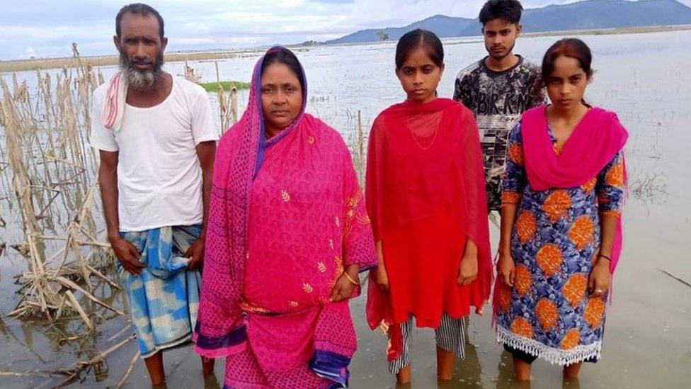 Lal Banu and her family in her inundated farmland in Dorang district of Assam state in Northeast India