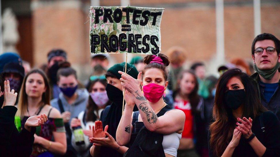 Protester holding sign on College Green