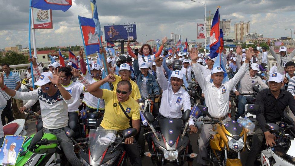 CNRP supporters cheering with flags during a rally