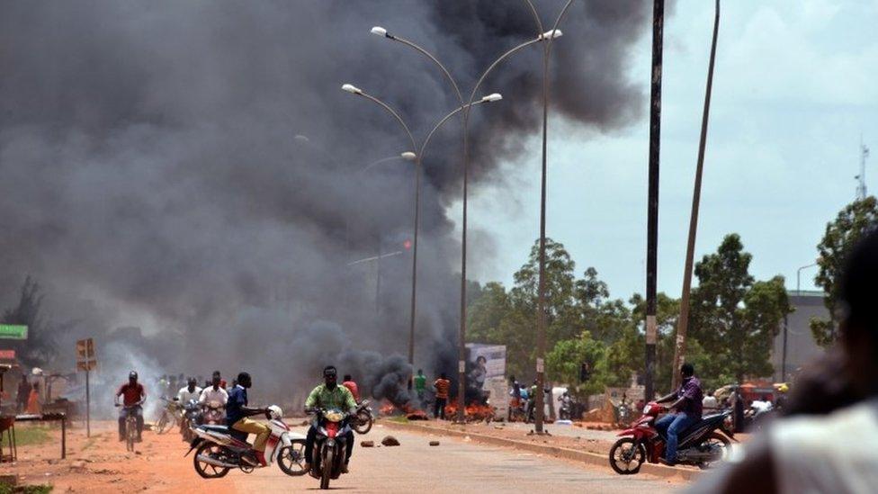 Residents burn tyres along a street in Ouagadougou on September 17, 2015