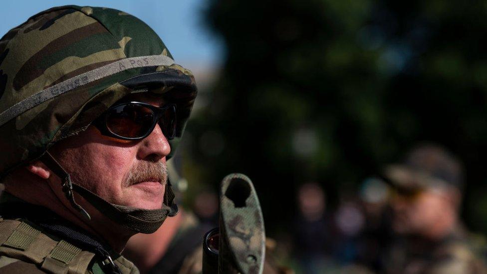 Members of local militia join second amendment advocates in a march from the capitol building to the Michigan Supreme Court building on September 17, 2020 in Lansing, Michigan