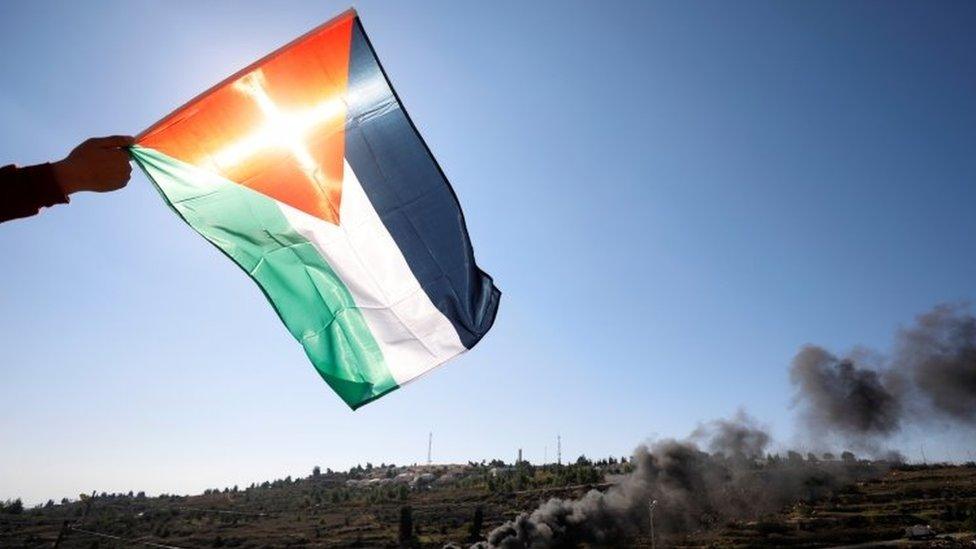 A Palestinian flag over protest near Israeli settlement (file photo)