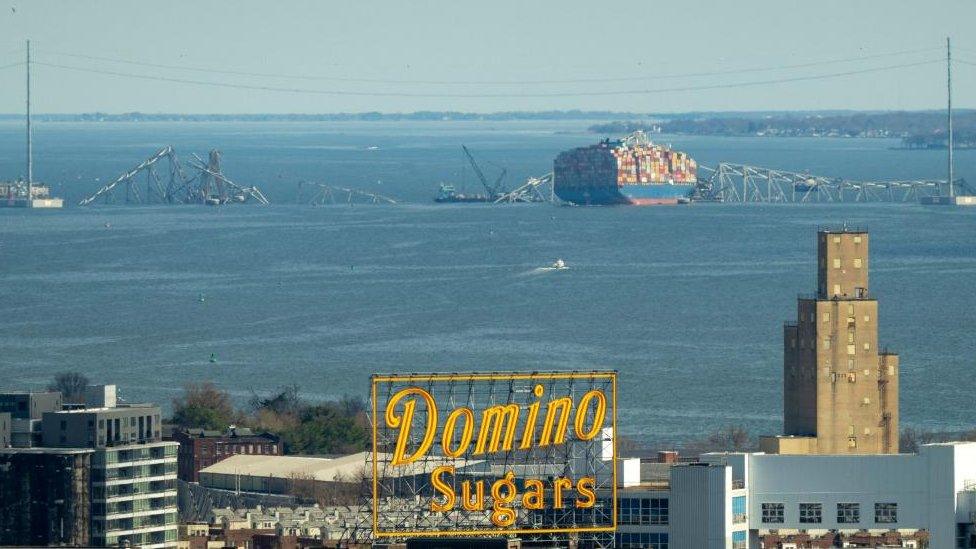 Salvage cranes on barges are anchored at the wreckage of the Francis Scott Key Bridge over the Patapsco River