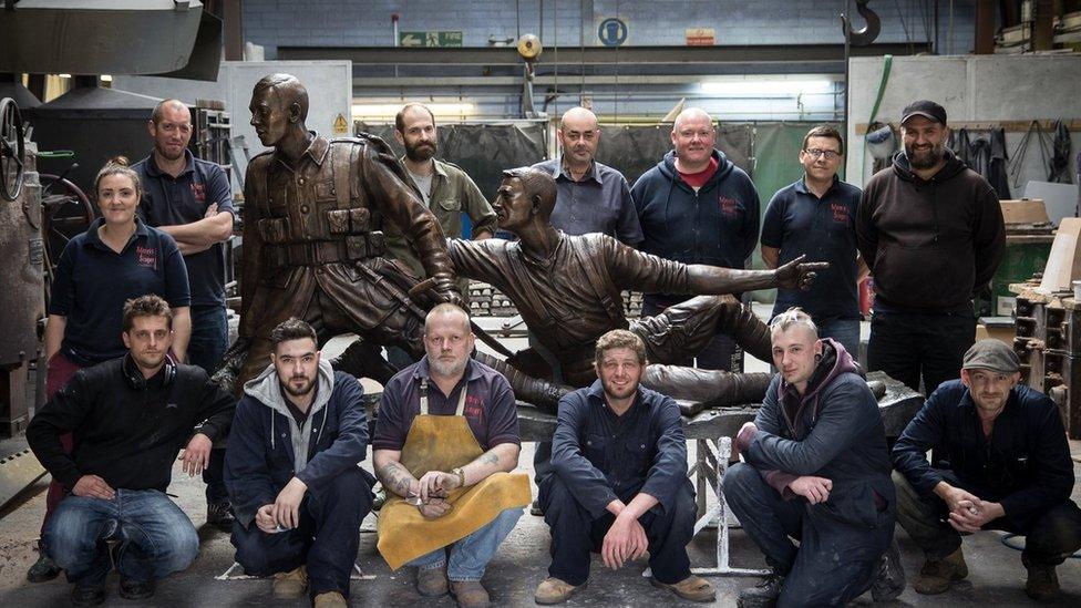 Members of the foundry with the finished statue