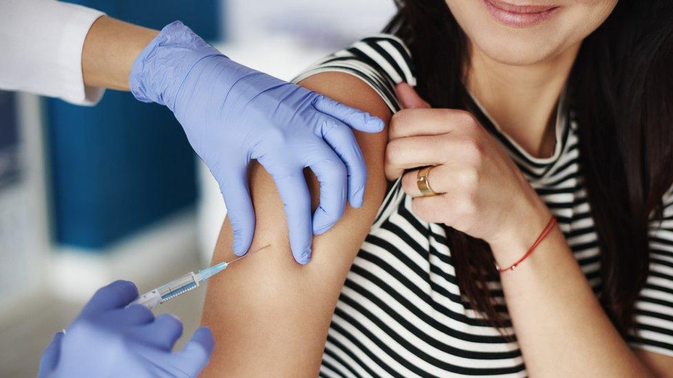 woman getting injection in her upper arm