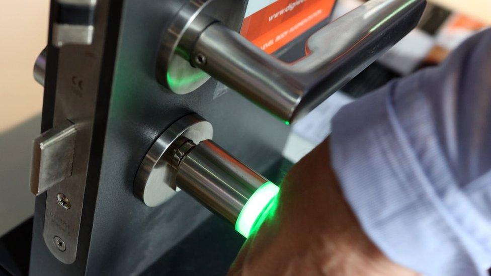 A man uses the microchip implanted in his hand to open a door lock at a press preview of the Wear-it festival in Berlin on 8 June, 2017