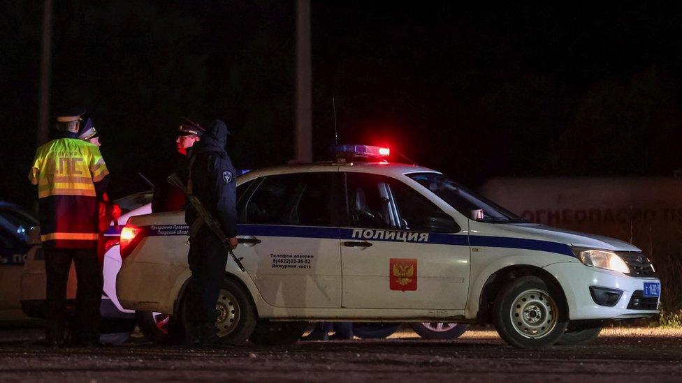 Russian police next to a police car