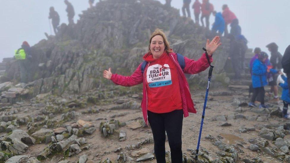 woman climbing mountain