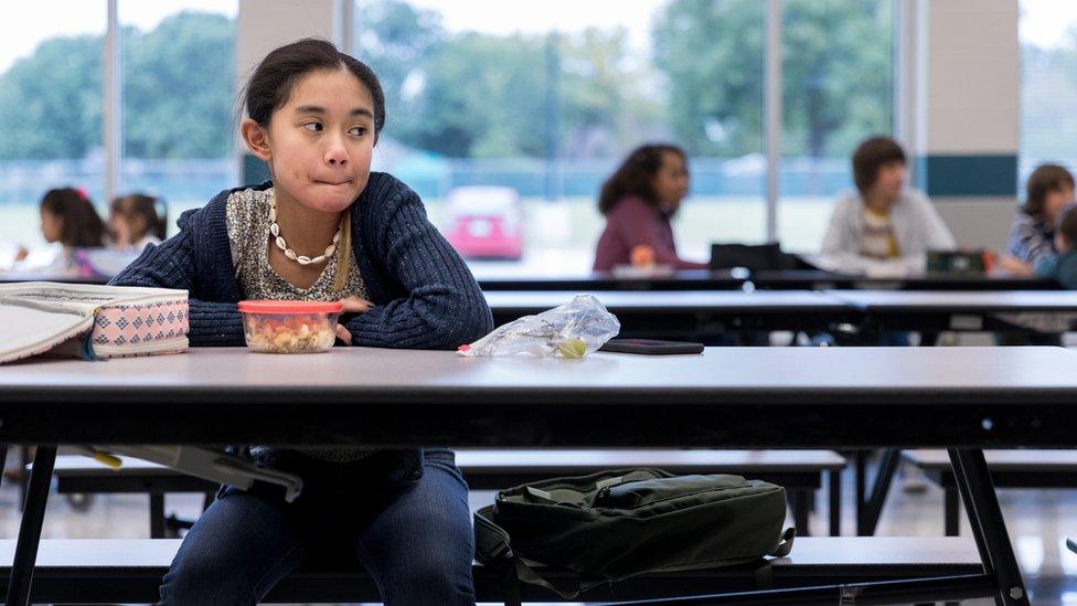 girl-sat-at-lunch-table