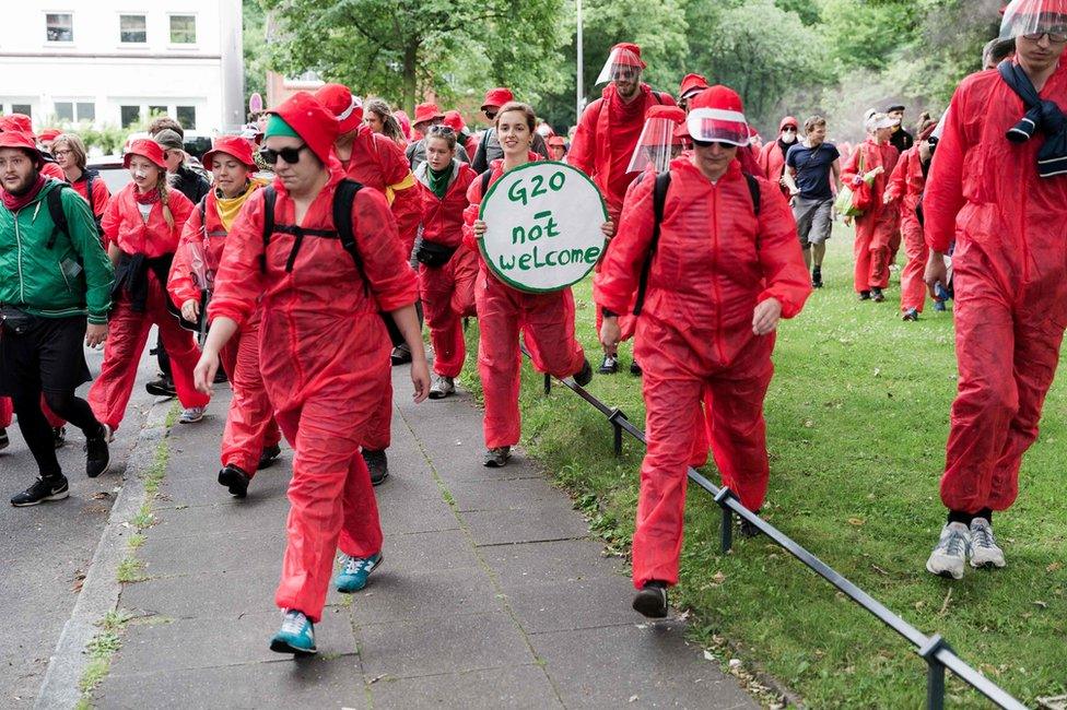 Demonstrators take part in a protest entitled "Colour the Red Zone" in Hamburg, 7 July