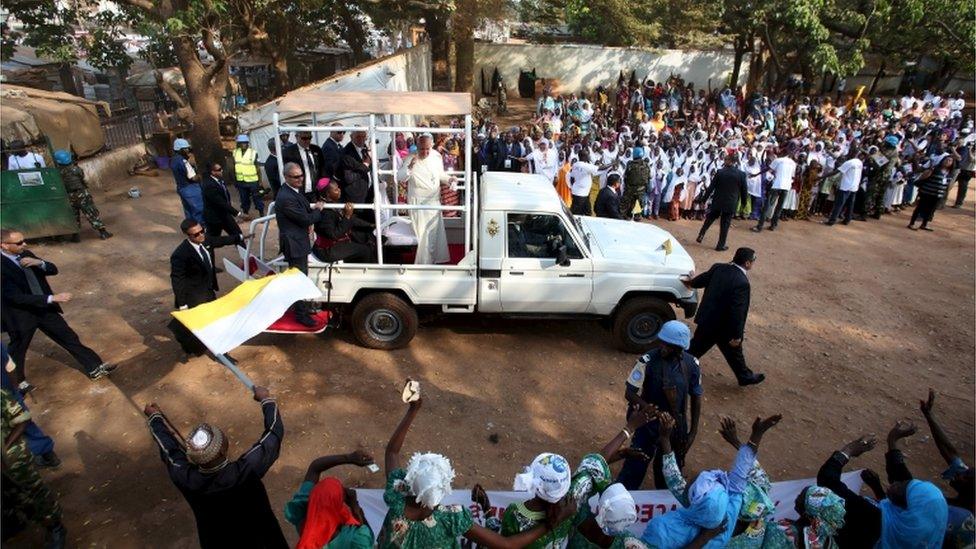 Pope Francis greets people as he arrives at the central mosque in the mostly Muslim PK5 neighbourhood of the capital Bangui, Central African Republic