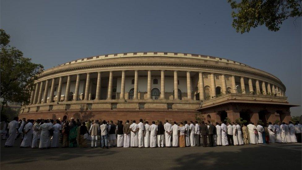 Indian lawmakers from opposition parties form a human chain outside the parliament building during a protest against the government demonetizing high-value bills in New Delhi, India, Wednesday, Nov. 23, 2016.