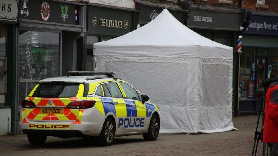 Police car and a white tent outside The Clean Plate