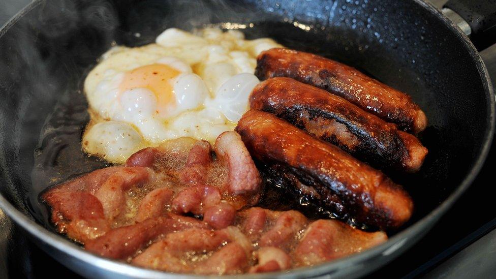 Sausage, egg and bacon in a frying pan