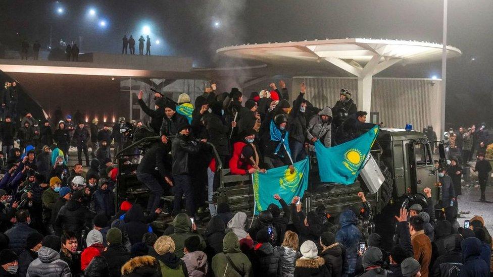 Protesters take part in a rally over a hike in energy prices in Almaty on January 5