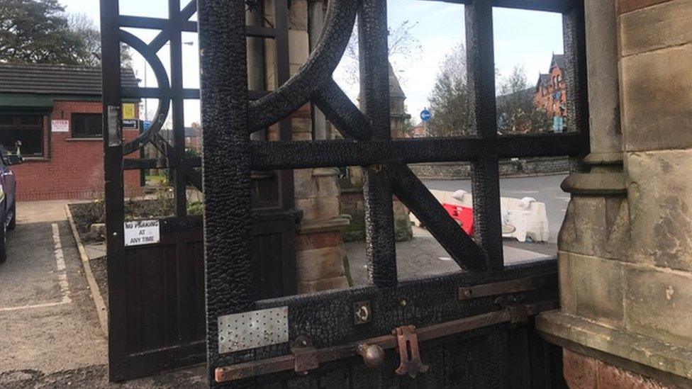 Charred gates at Milltown Cemetery