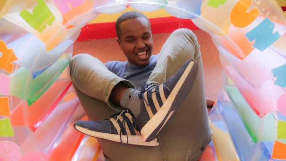 Young person playing inside an inflatable ring