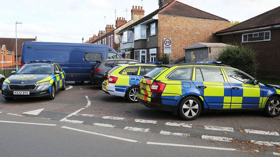 Police cars blocking a road entrance