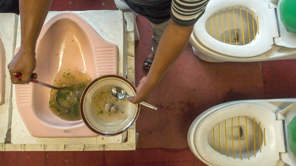 Soup being served from a toilet bowl.