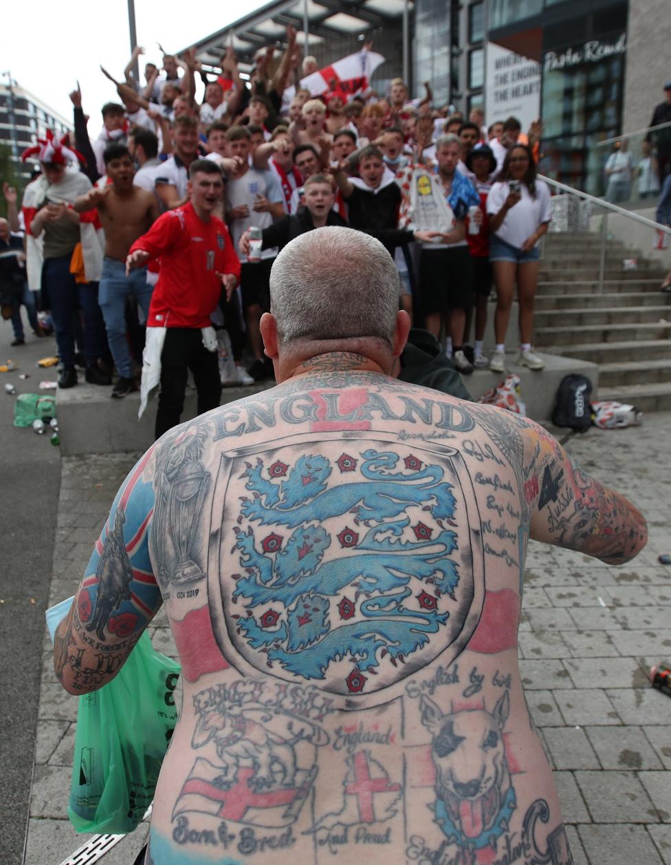 A fan is seen with England tattoos on Wembley Way outside Wembley Stadium, on 11 July 2021