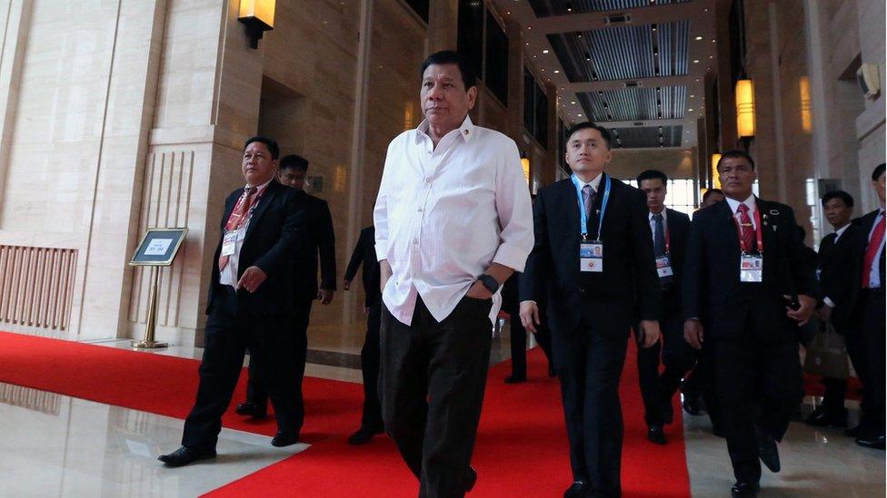 A handout picture released by the Presidential Photographers Division (PPD) shows Philippines President Rodrigo Duterte (centre, hands in pockets) walking to attend a meeting during the Association of Southeast Asian Nations (ASEAN) Summits at the National Convention Centre (NCC) in Vientiane, Laos, 6 September 2016.